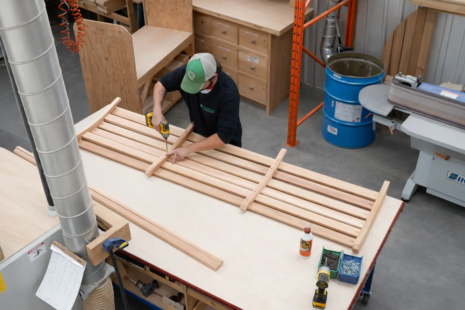 LeisureCraft craftsman assembling a cedar sauna bench in the workshop